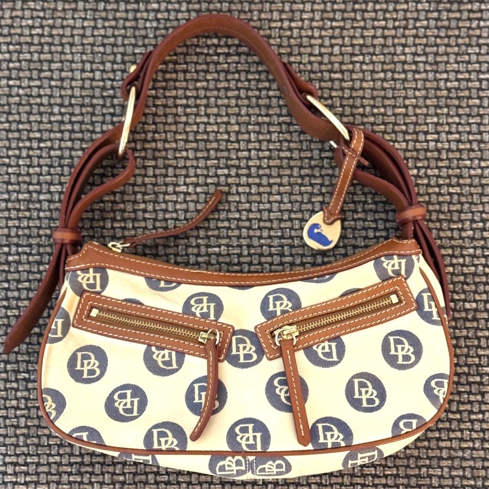 Dooney & Bourke bag. Cream and light grey with tan leather handle trim.